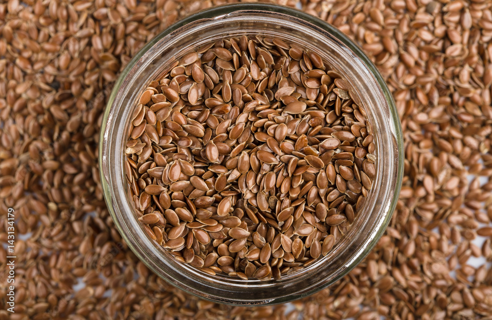 close up of flax seeds isolated on white background. Bowl full of brown flaxseed or linseed. Cereals. Vitamins. Healthy food. close up of flax seeds isolated on white background. Bowl full of brown flaxseed or linseed. Cereals. Vitamins. Healthy food.