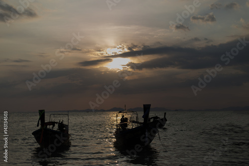 Traditional thai longtail boat at sunset on the Beach. Thailand, Krabi province