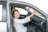 Elderly woman on car