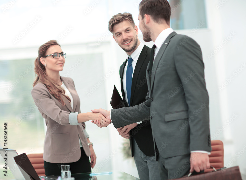 Handshake between business people in a modern office