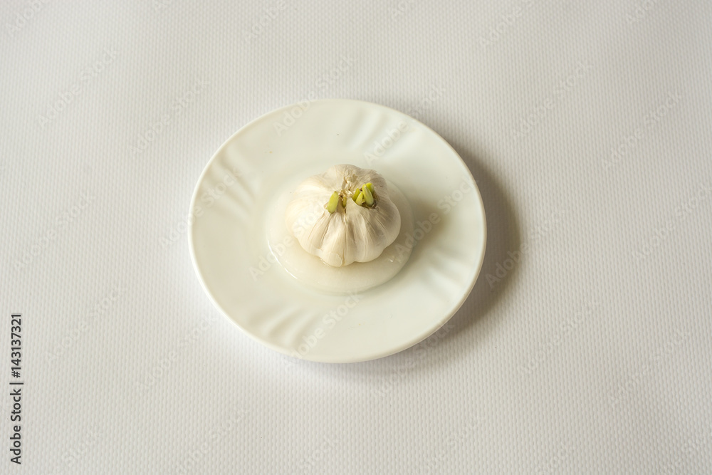 Garlic set in the dish with water. Garlic set in the dish with water.