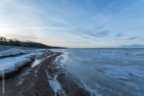  Winter landscape. Coast line. Sea covered blocks of ice.