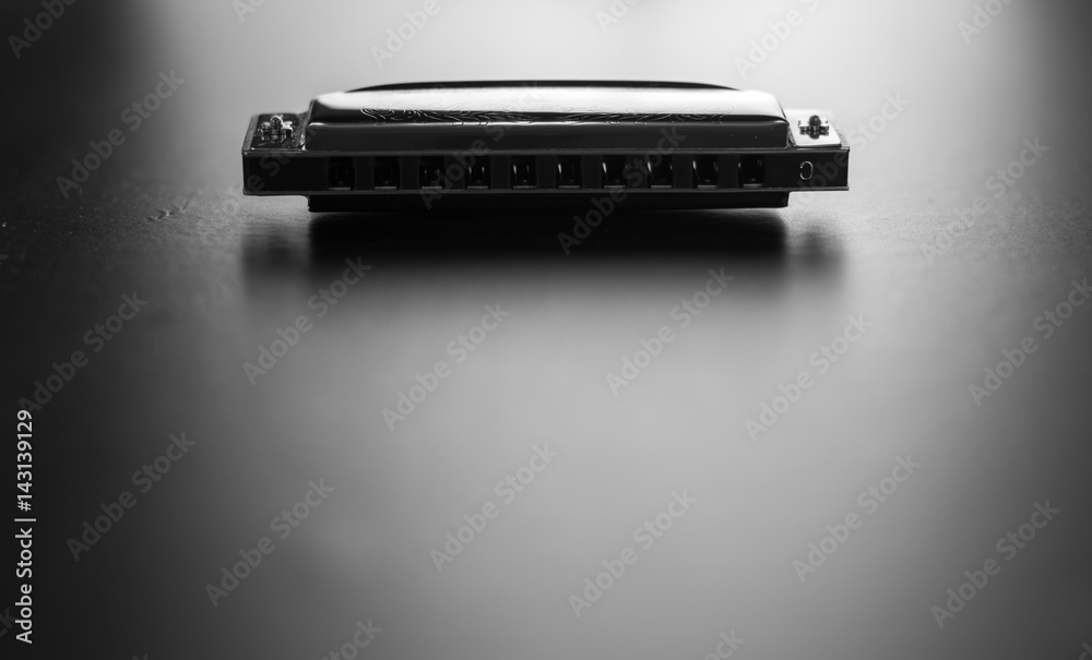 Harmonica isolated on black background. Black and white photography. Harmonica isolated on black background. Black and white photography.