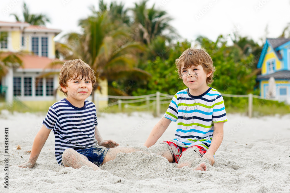 Two little kids boys having fun on tropical beach Two little kids boys having fun on tropical beach