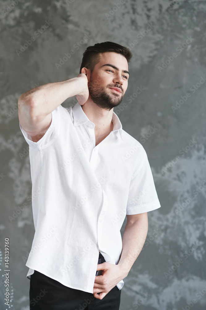Man posing in white shirt grey background Man posing in white shirt grey background