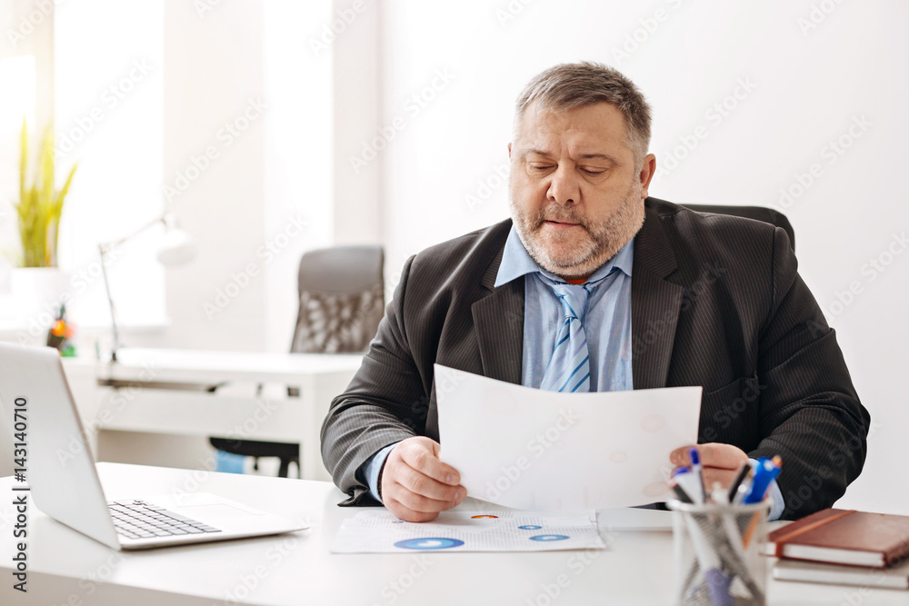 Scrupulous supervisor perusing unpleasant report Scrupulous supervisor perusing unpleasant report