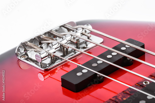 Metallic volume treble guitar bass knobs. Electric guitar. Red electric bass guitar close-up. Musical instrument. Music. Four strings. Grif.