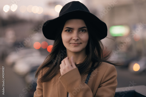 Portrait of woman in hat at city background
