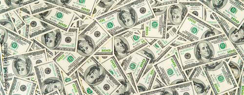 Background from scattered dollar banknotes as abstract seamless.
