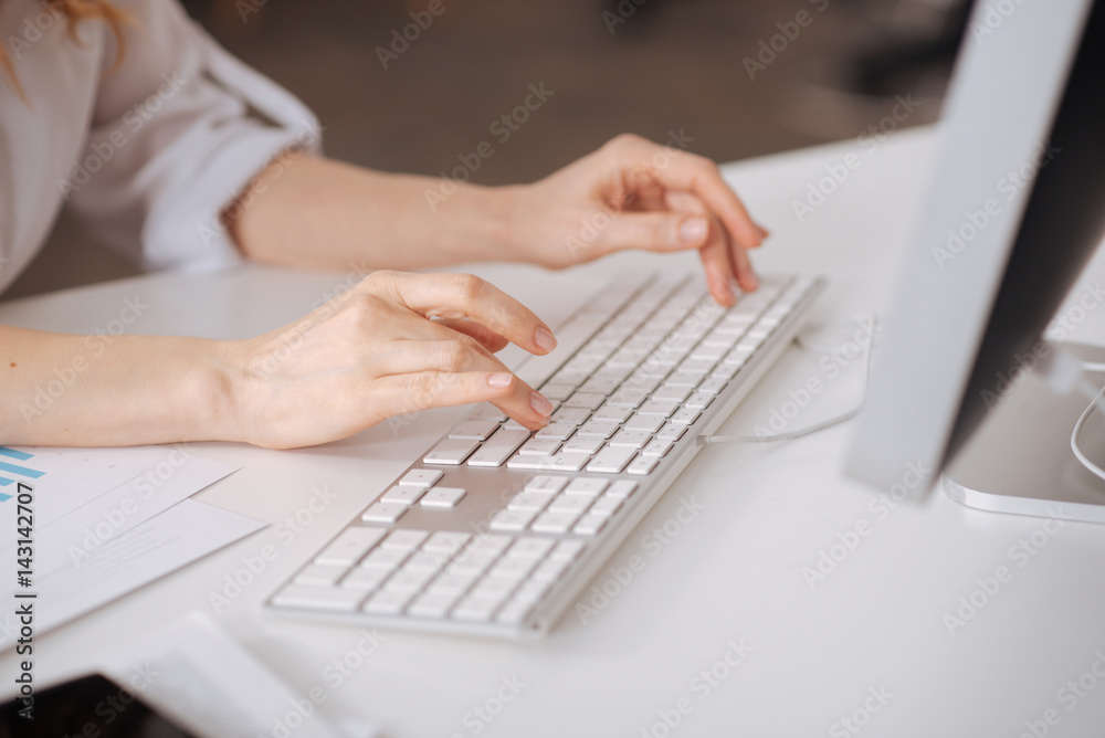 Hardworking young manager typing in the office Hardworking young manager typing in the office