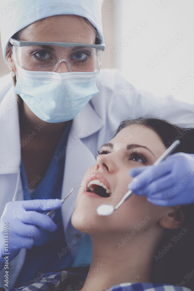 Woman dentist working at her patients teeth Woman dentist working at her patients teeth
