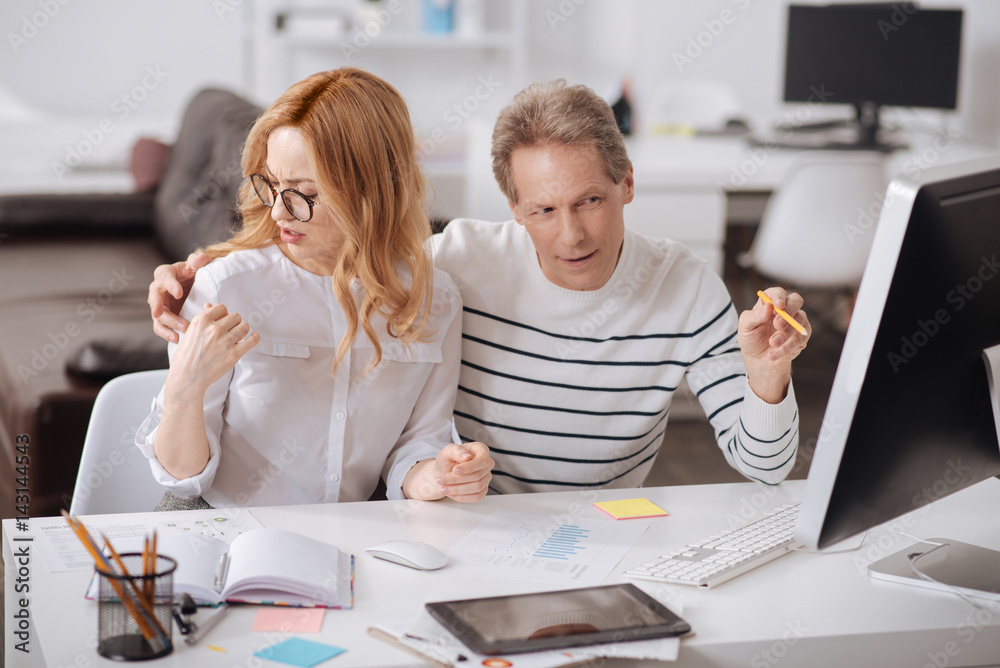 Astonished young secretary expressing negative emotions at work Astonished young secretary expressing negative emotions at work