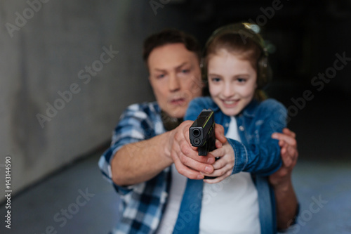 Nice exited girl aiming at the target photo