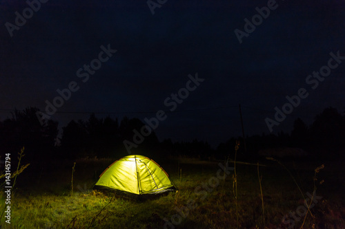 Tent at night in the field. Starry night.