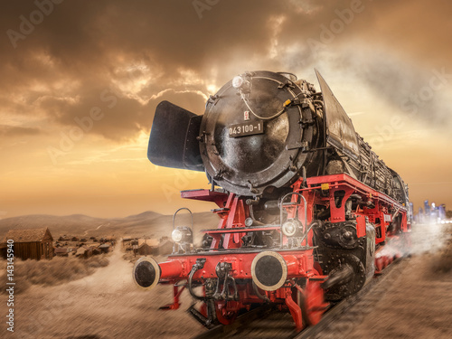 Steam locomotive drives through the desert