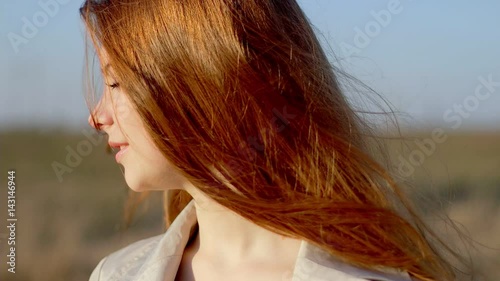 Portrait of a redhead girl at sunset photo