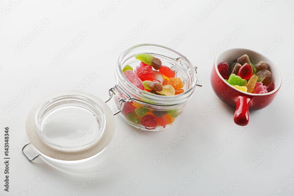 Ceramic and crest containers with candies on white background. Ceramic and crest containers with candies on white background.
