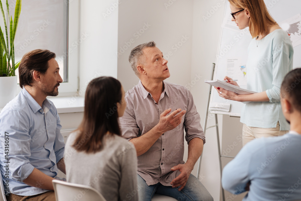 Confident man talking to his secretary Confident man talking to his secretary