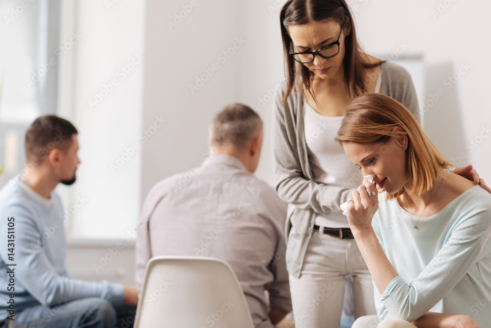 Serious brunette countenancing her female coworker Serious brunette countenancing her female coworker
