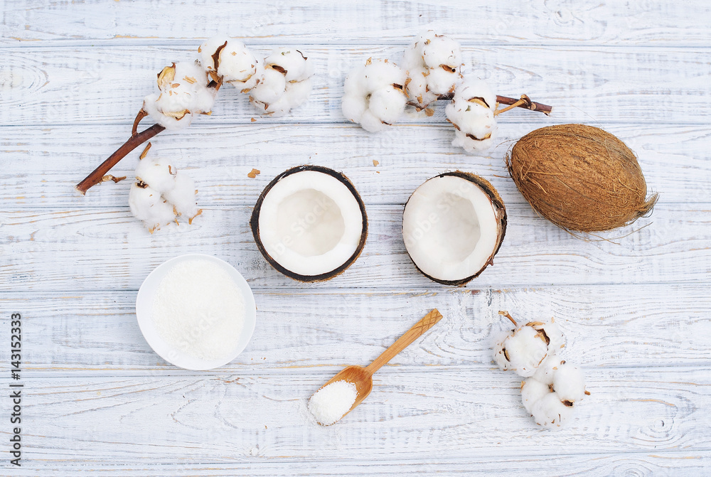 Still life with coconut, coconut flakes and white cotton flowers, healthy organic food concept Still life with coconut, coconut flakes and white cotton flowers, healthy organic food concept