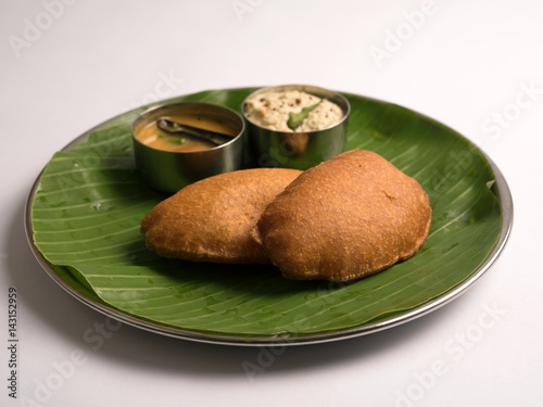 Onion Bajji or Vengayam bhaji with chutney sambar served in a banana leaf 