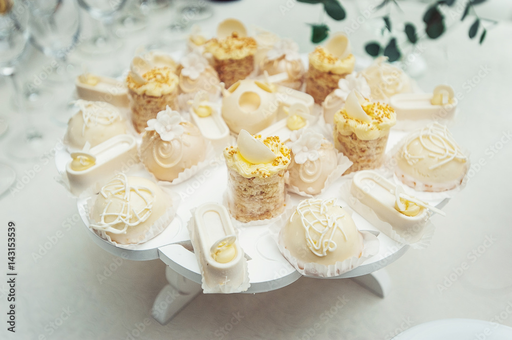 white Cakes and cupcakes on vintage white dish