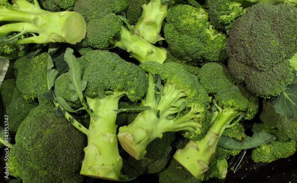 Pile of Green Fresh Broccoli on display for sale at local supermarket