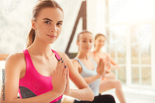 Close up of youthful women doing yoga.