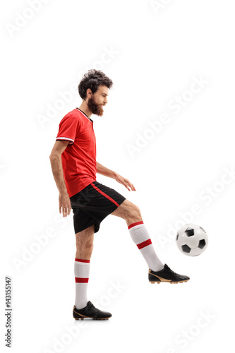 Bearded guy in a red jersey juggling a football