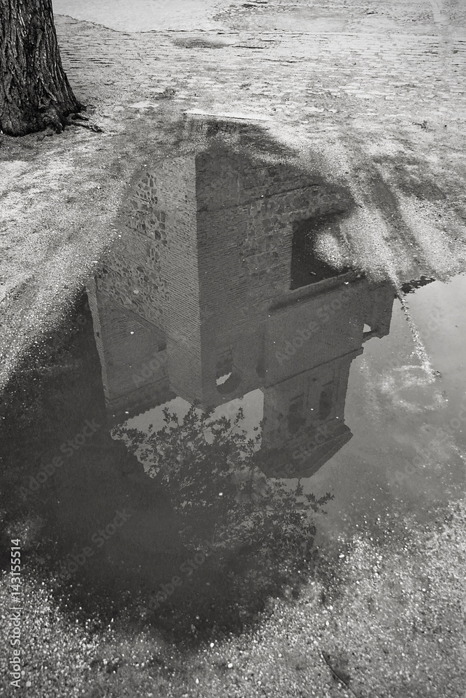 Building, puddle and reflection in black and white
