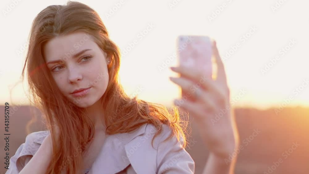 beautiful woman taking selfie using phone on beach at sunset smiling and spinning enjoying nature and lifestyle on vacation beautiful woman taking selfie using phone on beach at sunset smiling and spinning enjoying nature and lifestyle on vacation