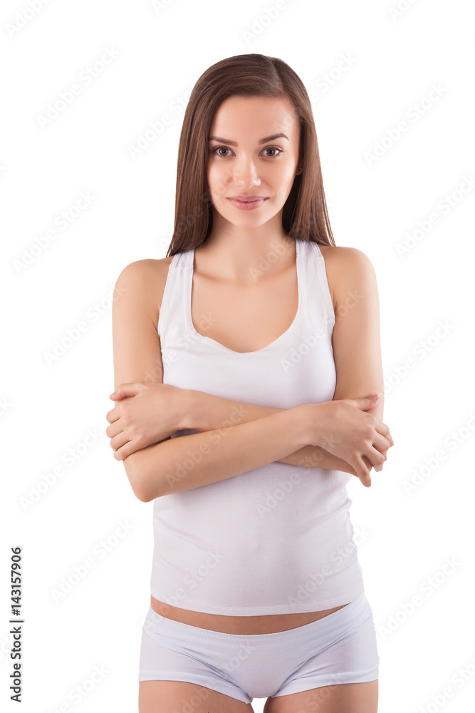 Young pretty woman standing at white isolated background and looking at camera. Beautiful girl with perfect body in clean white clothing. Young pretty woman standing at white isolated background and looking at camera. Beautiful girl with perfect body in clean white clothing.