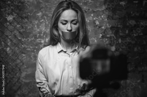 Photos Sad obedient hostage posing in front of the camera