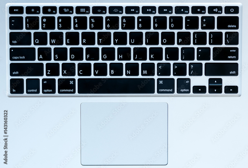 Foto Stock Top view image of silver laptop keyboard | Adobe Stock
