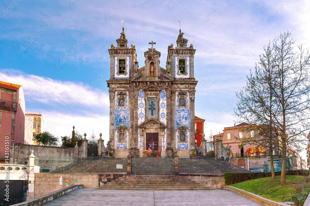 Beautiful old church of Saint Ildefonso or Igreja de Santo Ildefonso in a proto-Baroque style with facade covered with azulejos tiles in the sunny morning, Porto, Portugal