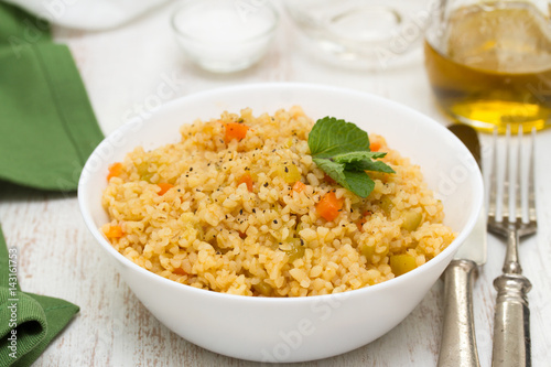 couscous with vegetables in white bowl