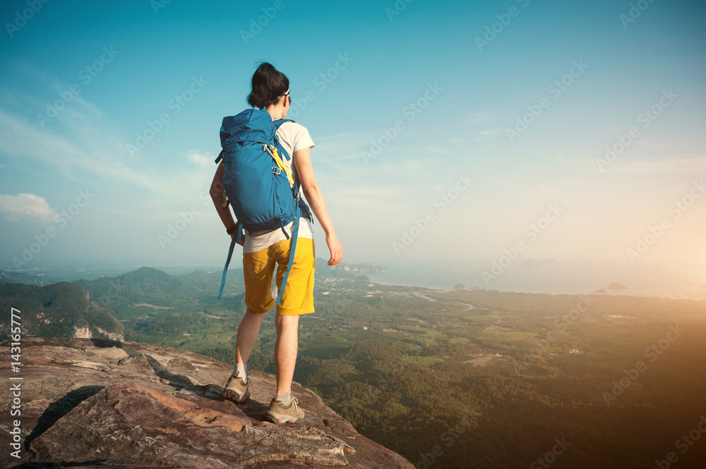 Fototapeta premium successful woman hiker enjoy the view hiking on mountain peak