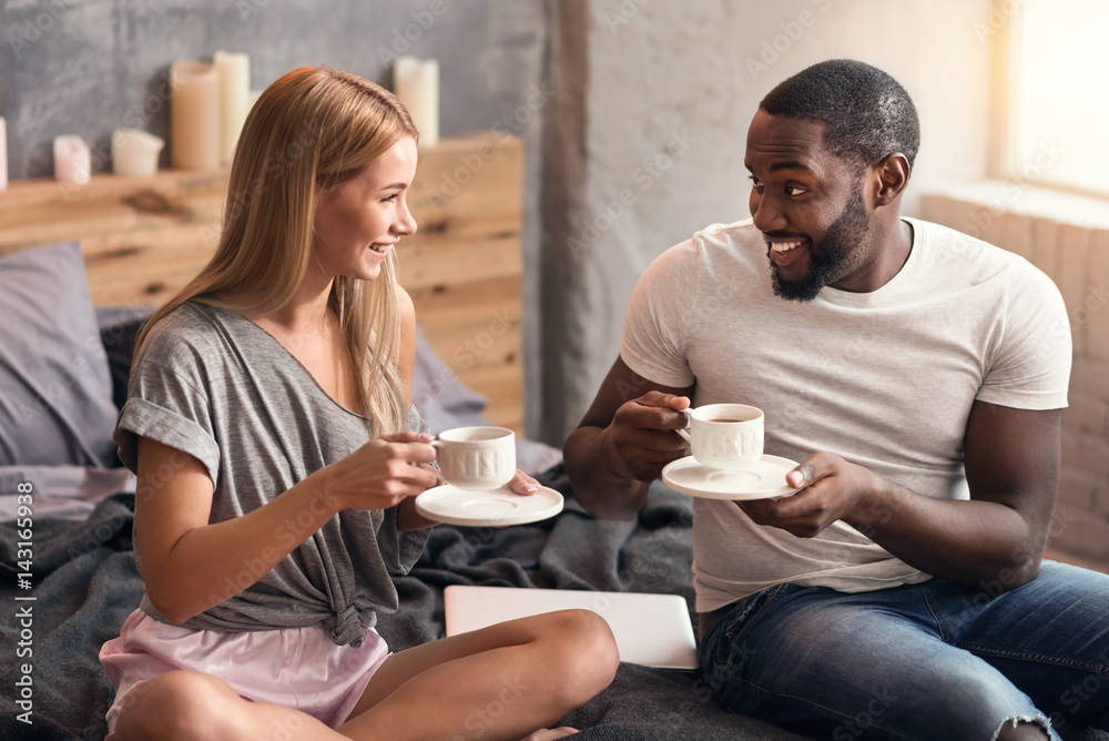Kind international couple enjoying weekend at home