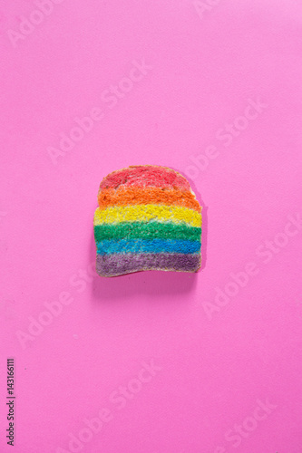 single rusk painted with rainbow colors, breakfast time, food design healthy concept