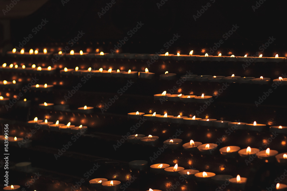 Lots of church candles in the dark. Selective focus Lots of church candles in the dark. Selective focus