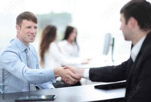 Business handshake. Two business people shaking hands in office.