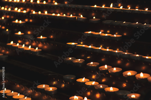 Lots of church candles in the dark. Selective focus