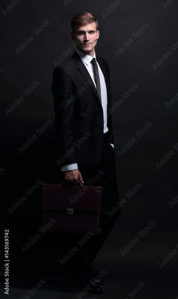 Full-length portrait of business man isolated on black backgr Full-length portrait of business man isolated on black backgr