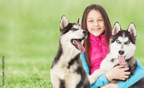 Girl and Siberian husky On the green grass