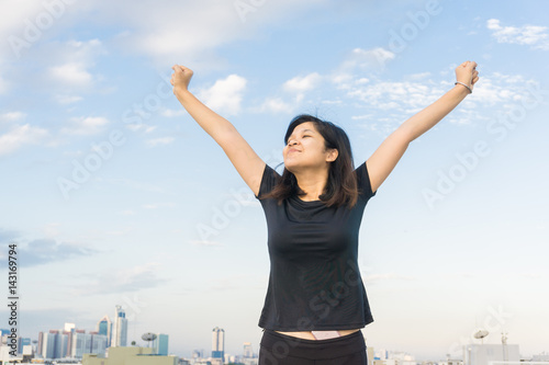 Women stretch body on top of building for running