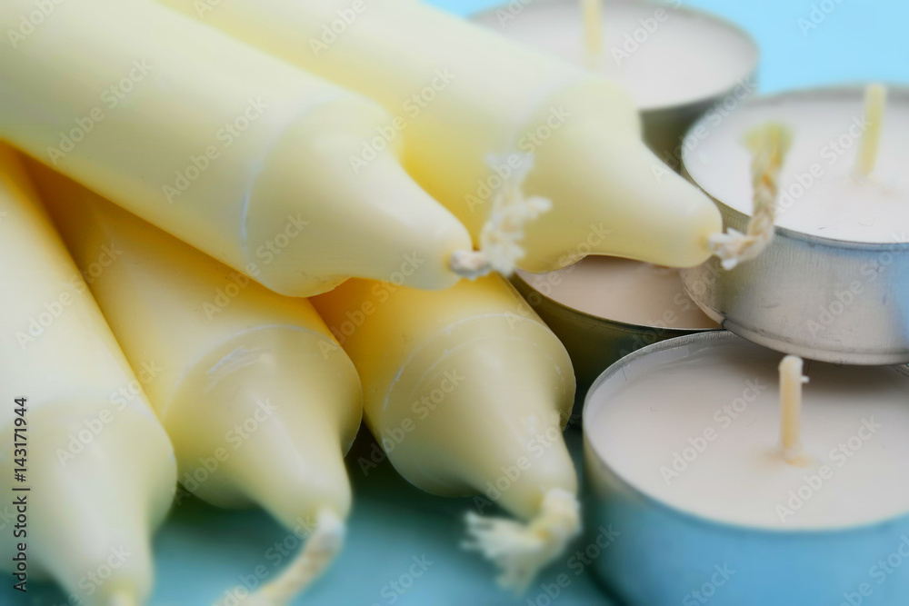 White candles on light blue background. Tilt-shift effect applied. White candles on light blue background. Tilt-shift effect applied.