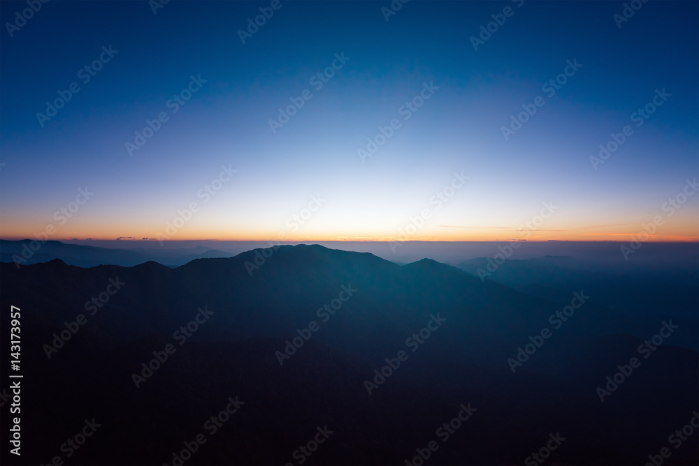 Great sunrise above the mountain valley and morning mist.