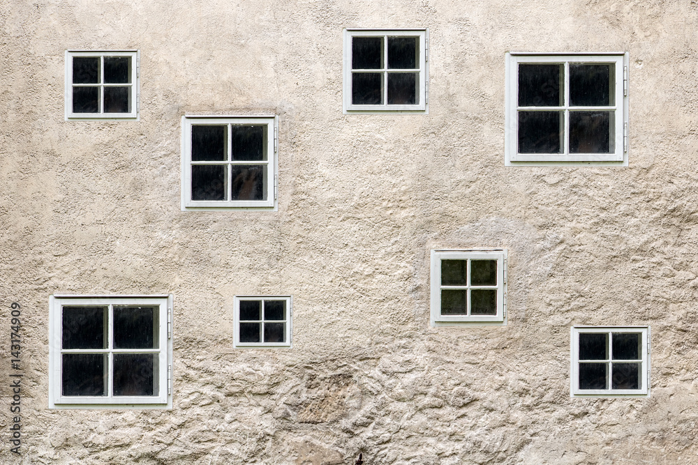 facade of an old building with small windows facade of an old building with small windows