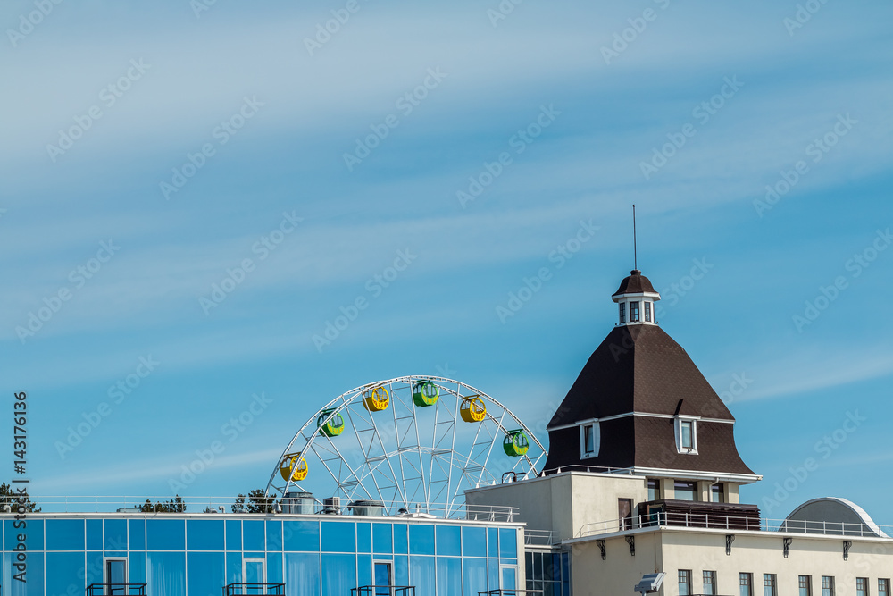 Obraz premium Ferris wheel, big wheel, Fragment of grand Ferris Wheel . modern buildings. Glass building. Hotel view
