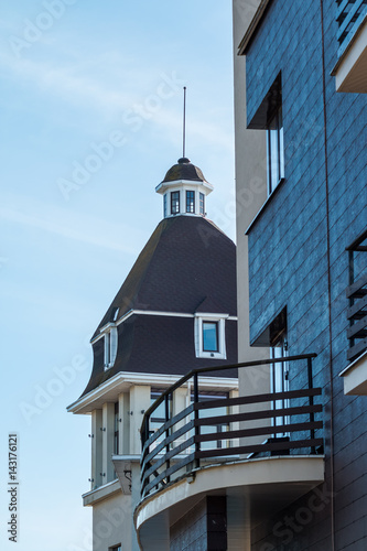 modern architecture. Small tower on the roof of town hall building. beautiful European facade with modern windows © Yulia